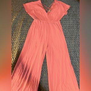 Peach colored jumpsuit with crisscross detail in front